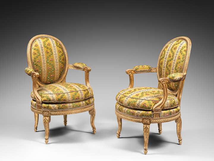 A rare pair of Louis XVI gilt wood armchairs